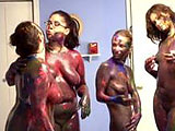 Holly, River, and Lulu are rubbing paint all over each other.  They are joined by Madelyn and they continue to completely cover their naked bodies in paint.